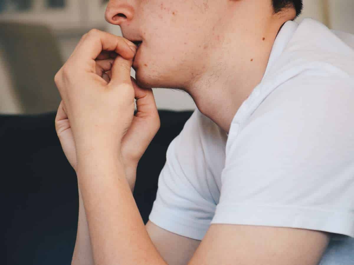 Young Man Biting His Nails In Washington Heights, NY