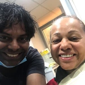 Dr. Arvind Philomin Next To Happy Patient In Washington Heights Dental Office