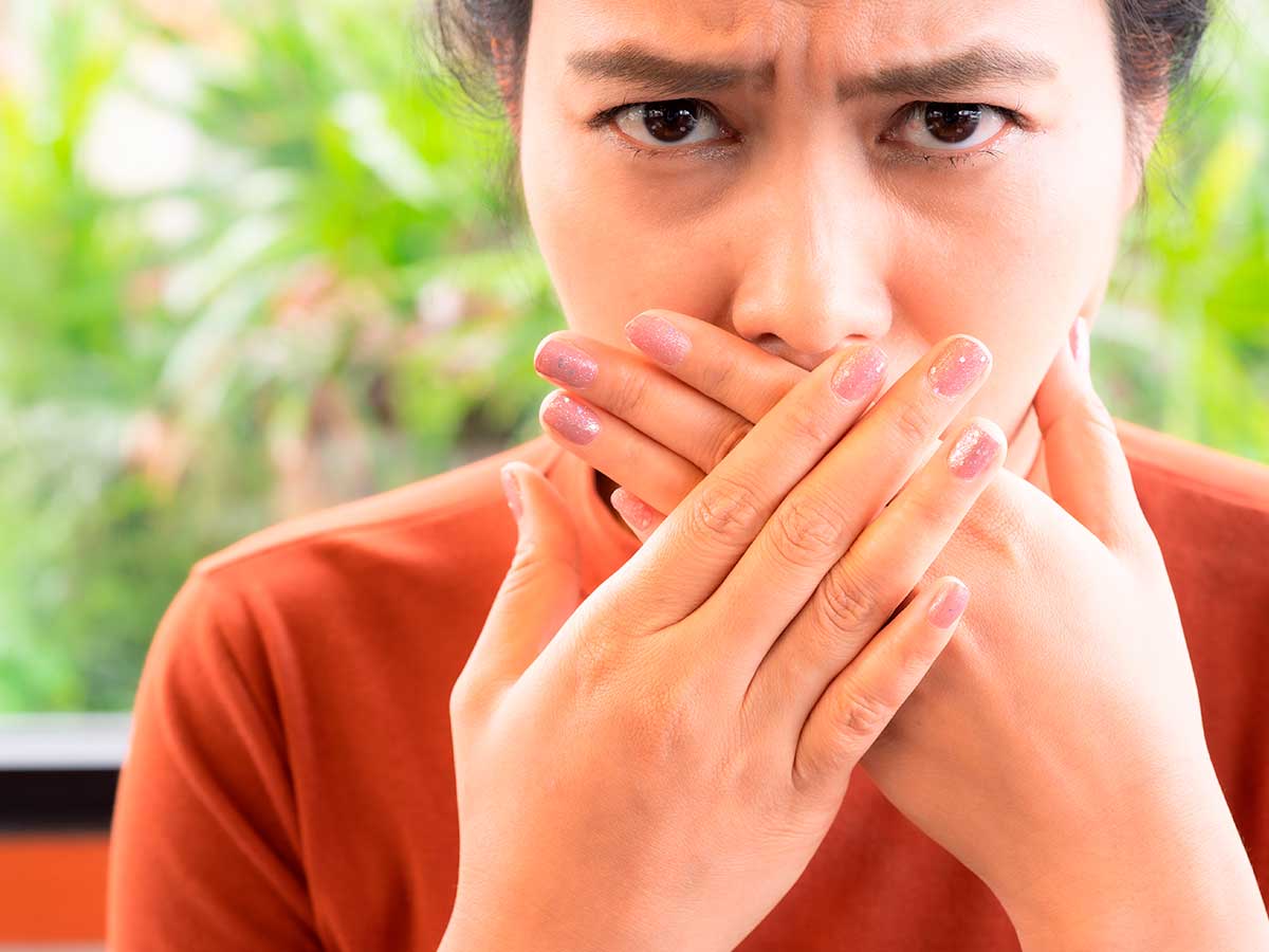 Woman Covering Her Mouth Because Of Bad Breath In Washington Heights