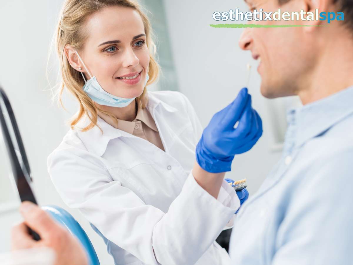 Dentist discussing dental implants color matching with a male patient