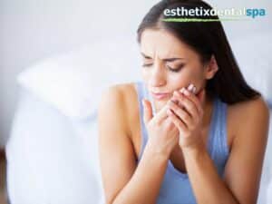 Woman experiencing tooth erosion pain, holding her jaw