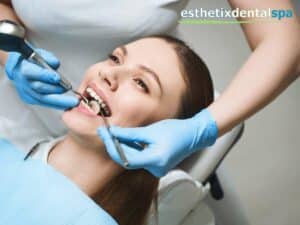 Smiling patient receiving Root Canal Therapy at Esthetix Dental Spa