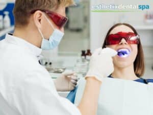 Dentist performing a Laser Dentistry procedure on a patient at Esthetix Dental Spa, using advanced technology for effective dental treatment